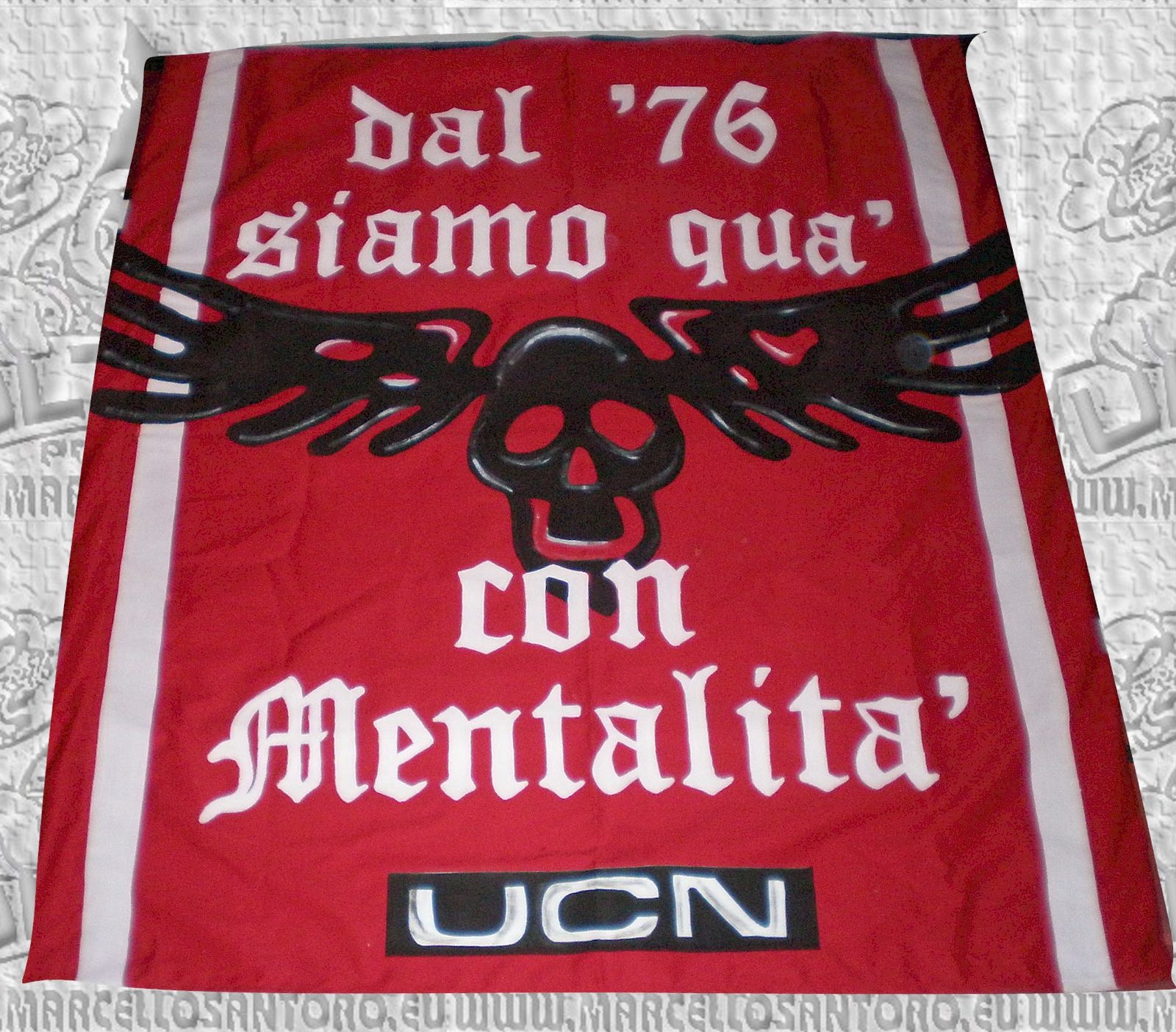 Telo stampato rosso con scritta commemorativa di un gruppo ultras